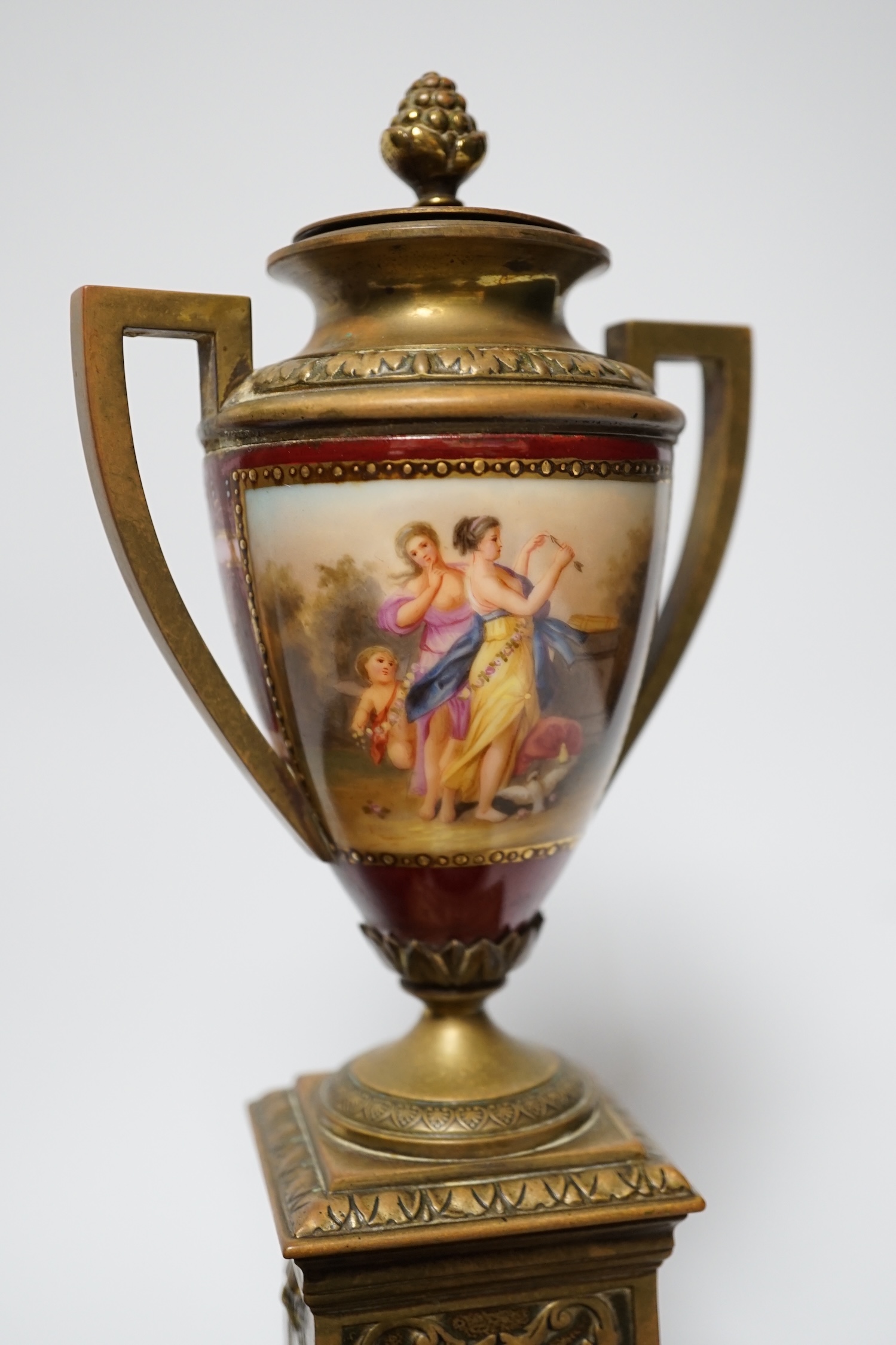 A pair of Vienna style brass mounted urns with enamelled classical scenes and six various Chinese carved hardwood stands, 23cm high